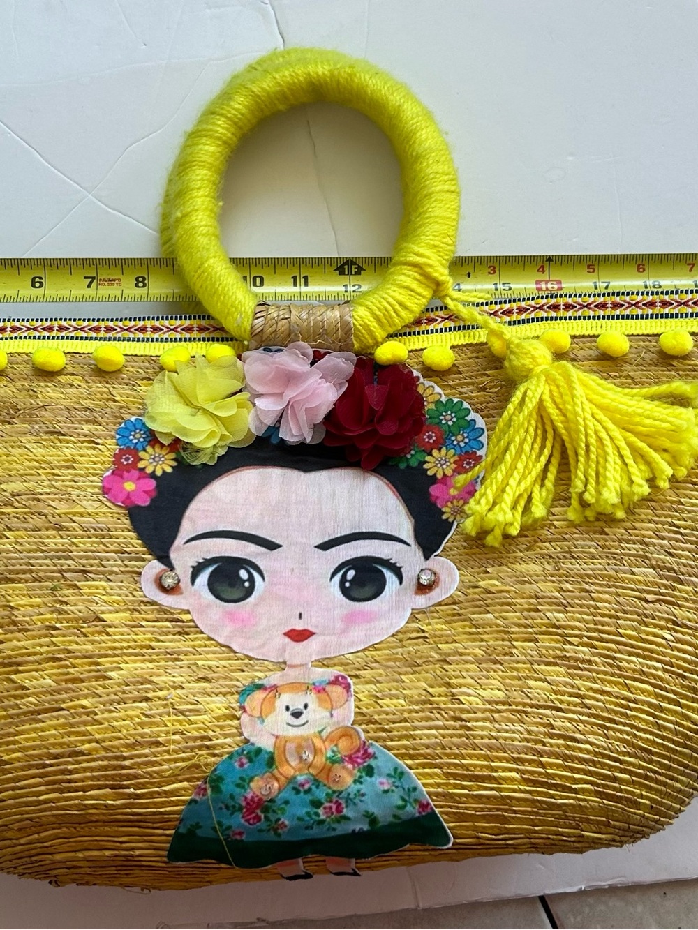 Yellow woman’s Straw Tote Bag with Decorative Frida Doll Accent